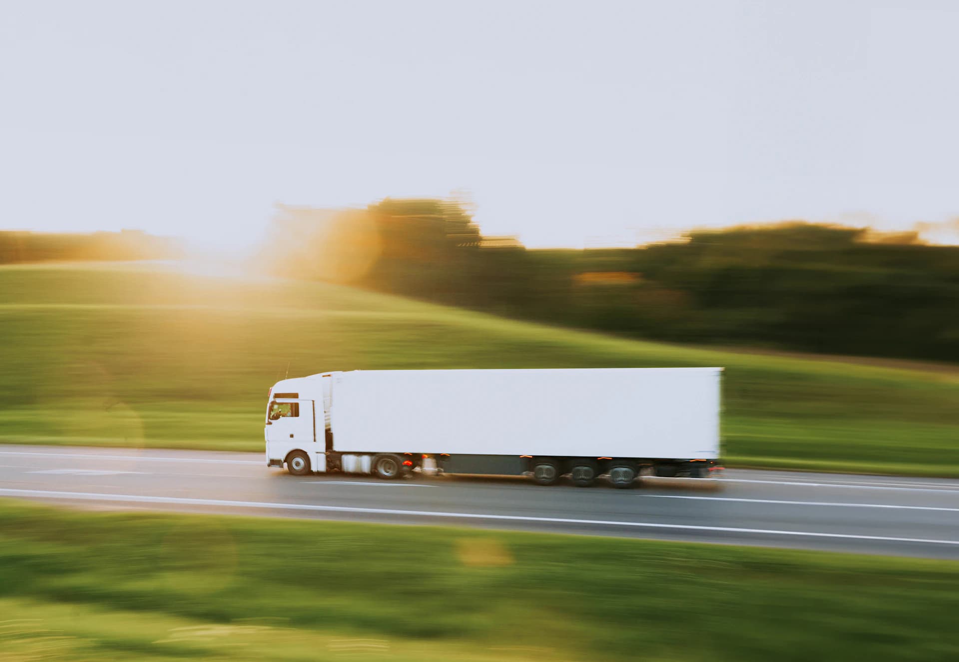 Moving truck traveling on an interstate highway through green countryside